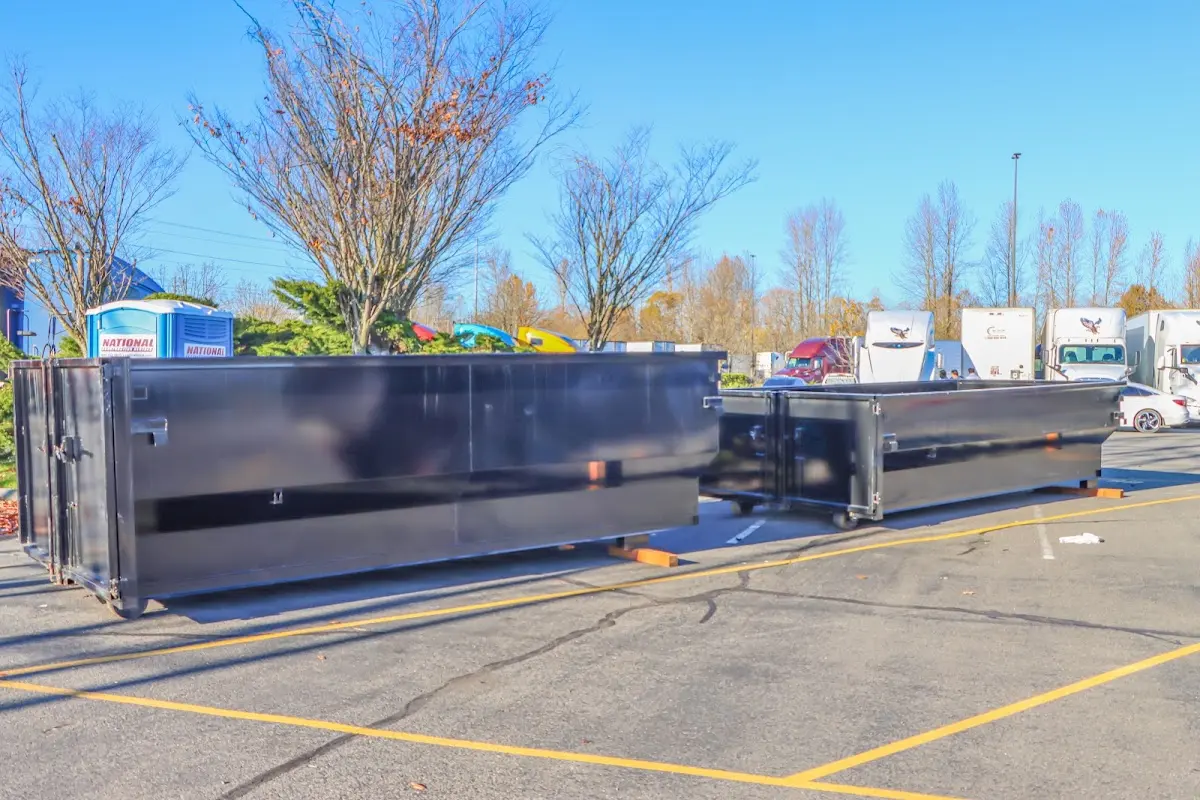 Professional dumpster rental service with roll-off container on residential driveway in Woodway